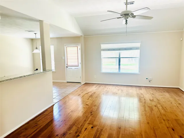 a view of a room with wooden floor and cabinet