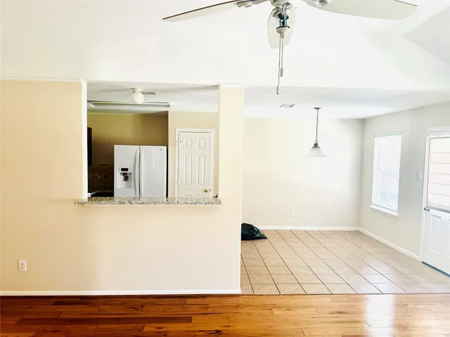 a large kitchen with stainless steel appliances granite countertop a refrigerator and a stove top oven