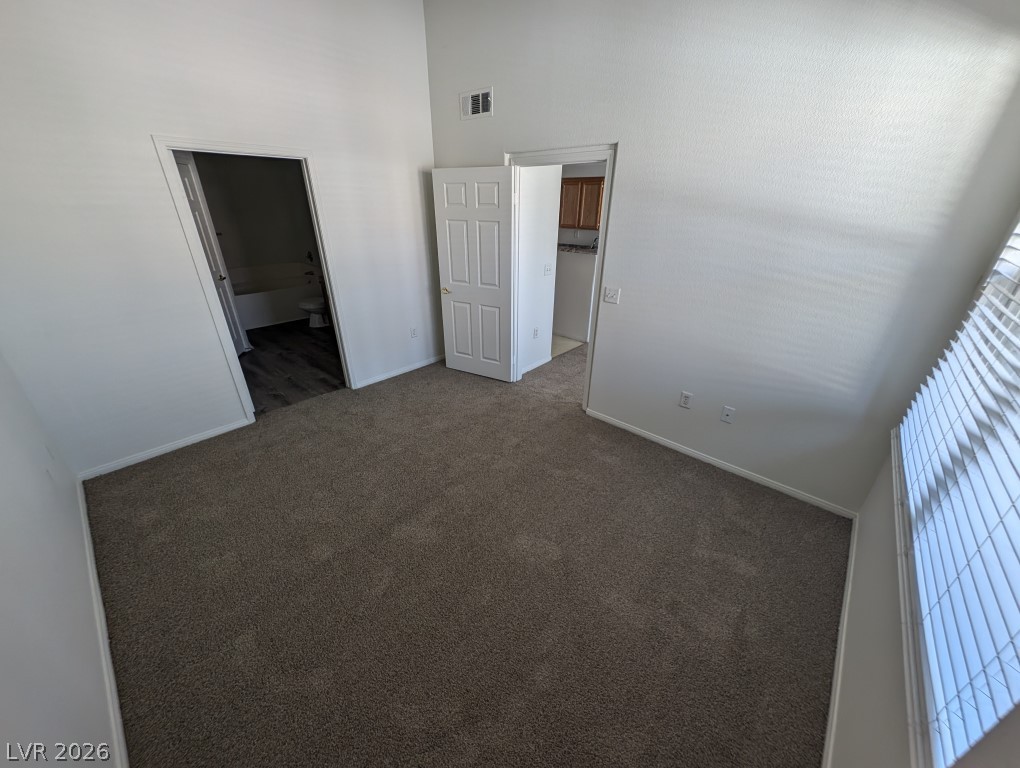 10550 West Alexander Road, Unit 2117 Las Vegas, NV 89129 - Photo 12 of 24 Vaulted ceilings and neutral plush carpeting define this spacious bedroom suite.