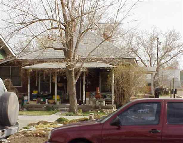a view of a patio with dining table and chairs with wooden floor and fence