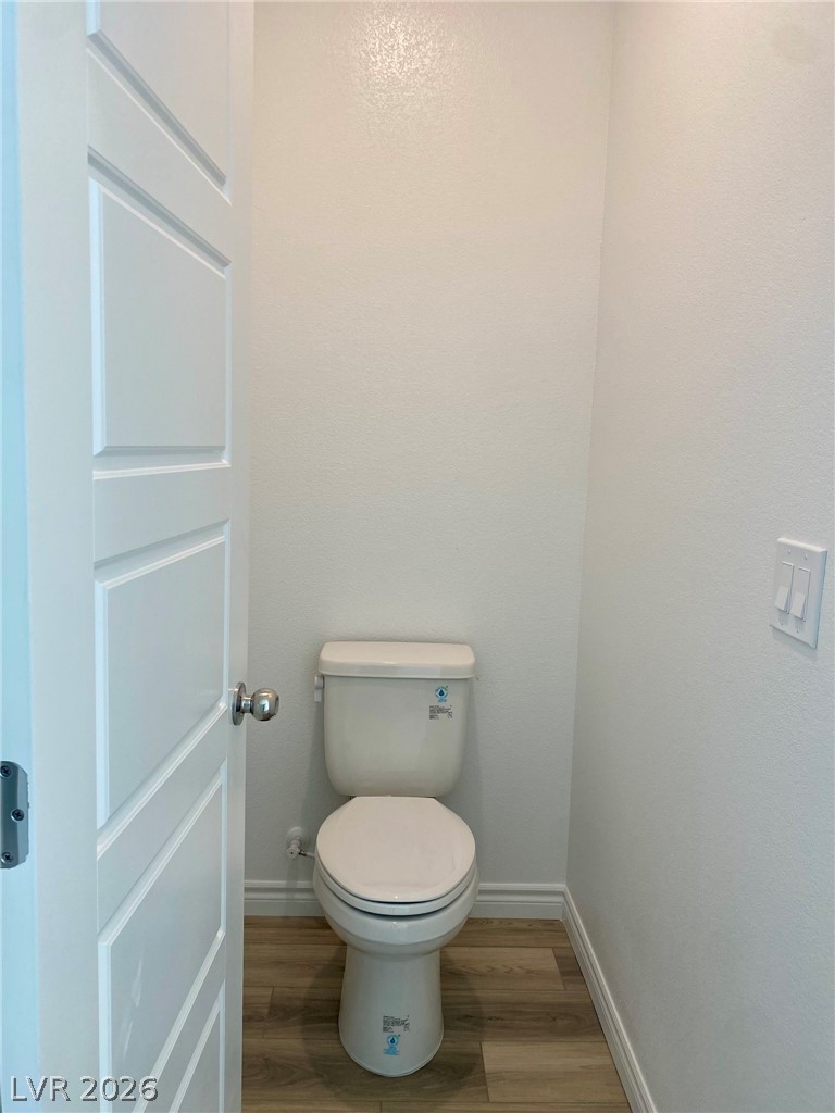 4457 Sawyer Ridge Street Las Vegas, NV 89147 - Photo 28 of 32 This clean and functional powder room features durable flooring and a classic toilet, perfect for daily use.
