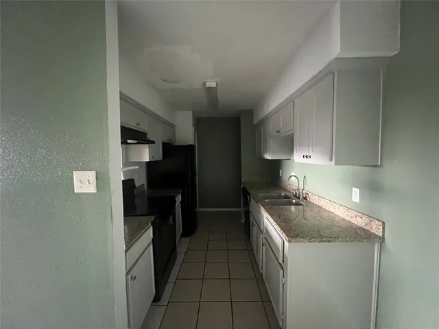 a kitchen with a sink and refrigerator