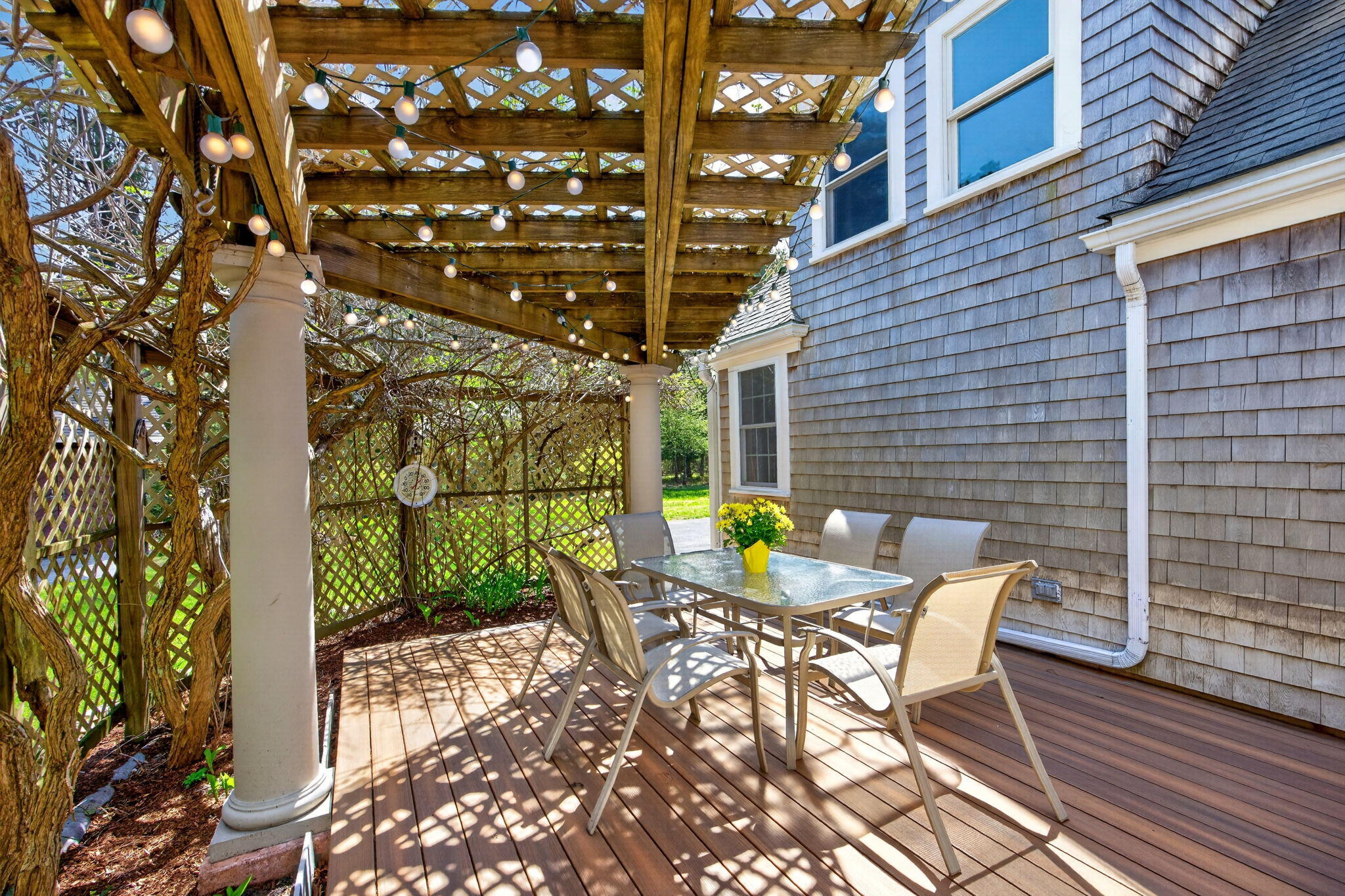 69 County Road Bourne, MA 02532 - Photo 38 of 54 a view of a patio with a table and chairs and wooden fence