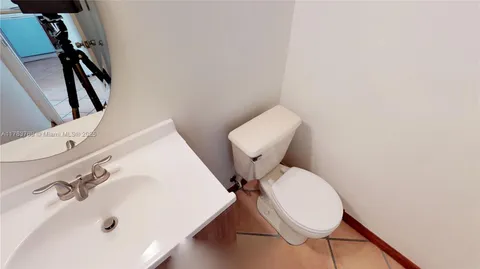 a bathroom with a sink mirror and toilet