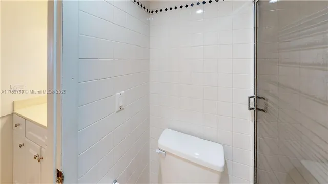 a white toilet sitting next to a bathroom sink