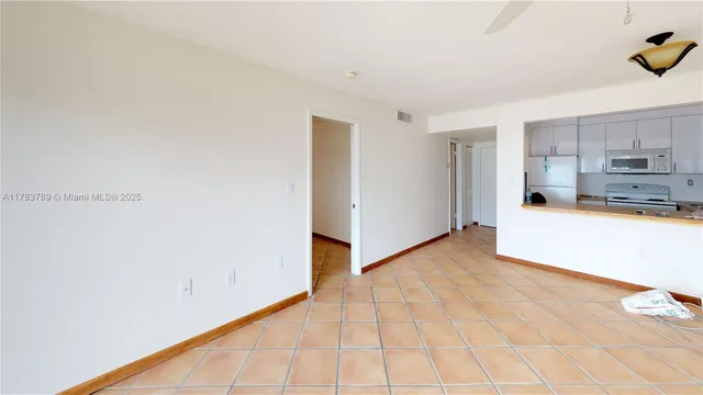 a view of a kitchen with microwave and cabinets