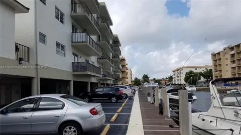 a front view of a building with palm trees