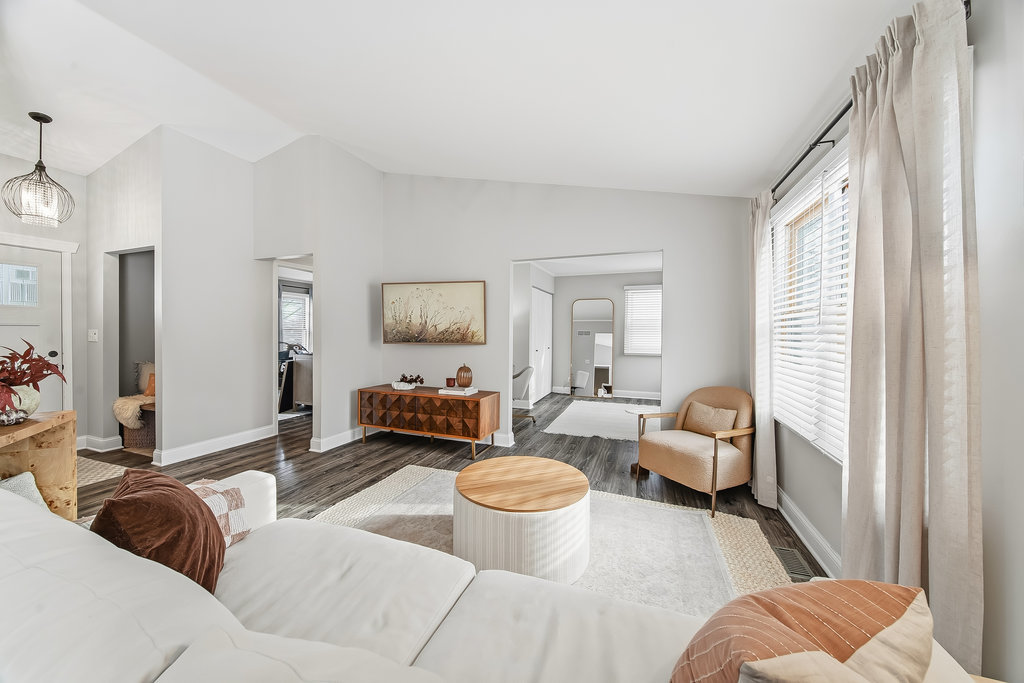752 North Brookdale Drive Schaumburg, IL 60169 - Photo 6 of 23 a living room with furniture and a large mirror next to a window