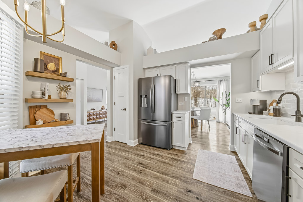 752 North Brookdale Drive Schaumburg, IL 60169 - Photo 10 of 23 a kitchen with stainless steel appliances granite countertop a refrigerator a stove and a sink with wooden floor