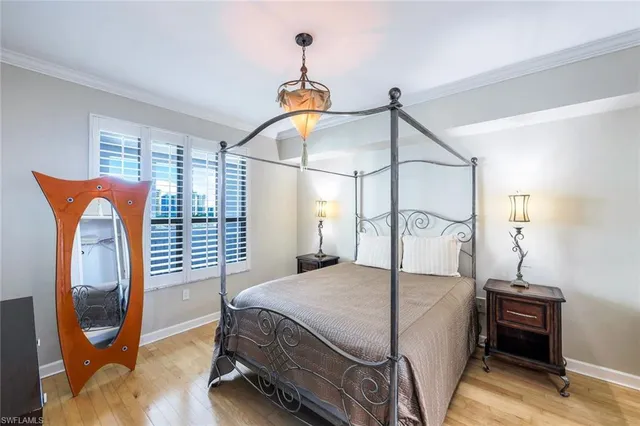 a bedroom with a bed a mirror and dresser