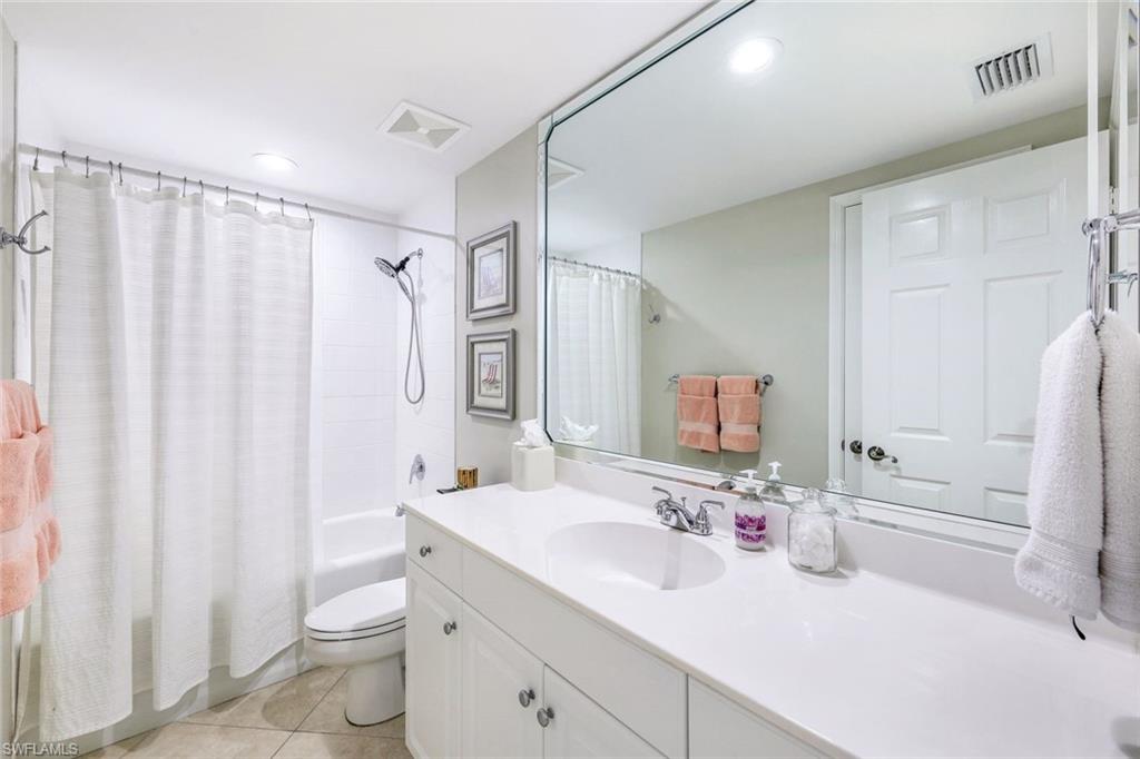 300 Dunes Boulevard, Unit 602 Naples, FL 34110 - Photo 15 of 18 a bathroom with a double vanity sink toilet and shower
