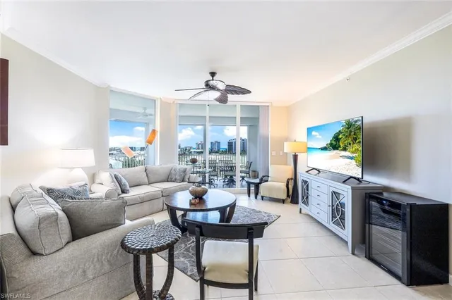 a living room with furniture and a kitchen
