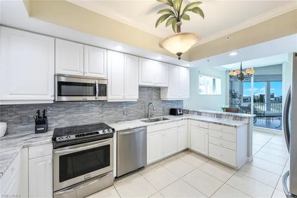 a kitchen with a sink stove and microwave