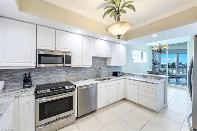 a kitchen with a sink stove and microwave