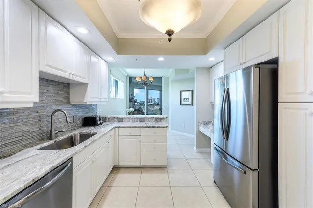 a kitchen with a sink stainless steel appliances and cabinets