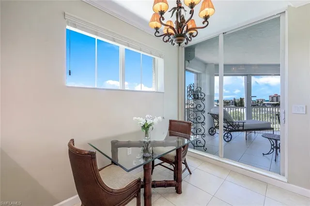 a view of a dining room with furniture wooden floor and chandelier