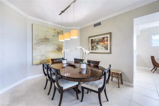 a view of a dining room with furniture and a window