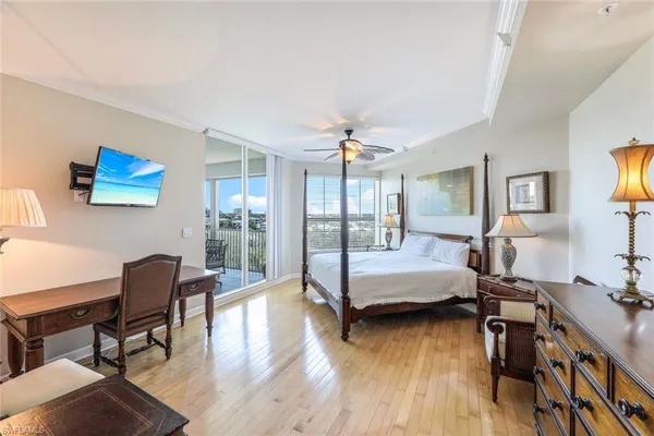 a bedroom with furniture and a wooden floor