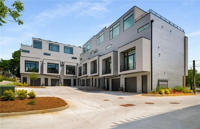 a view of a terrace with lawn chairs