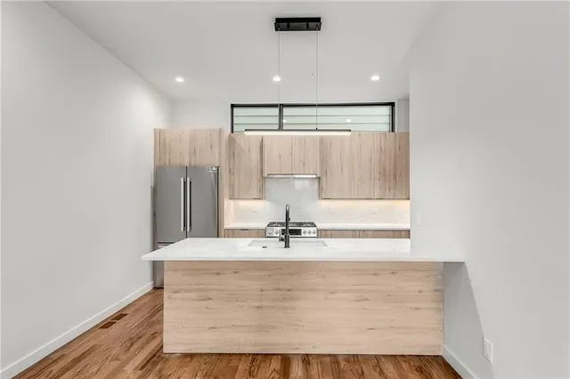 a view of kitchen with granite countertop cabinets and sink