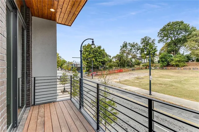 a view of a balcony with floor to ceiling windows with wooden floor