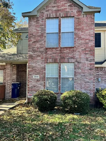a view of a house with a yard and plants