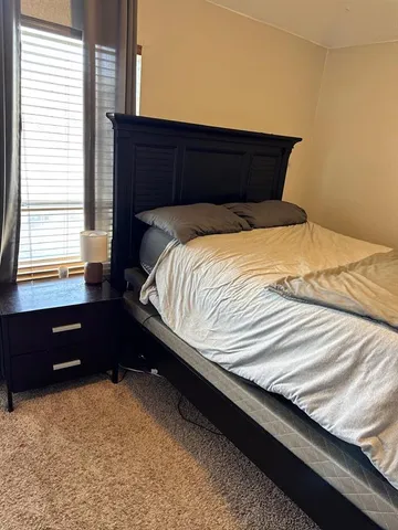 a bedroom with a bed and window