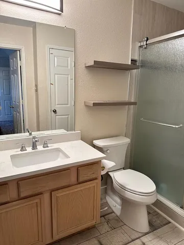 a bathroom with a toilet a sink and a mirror