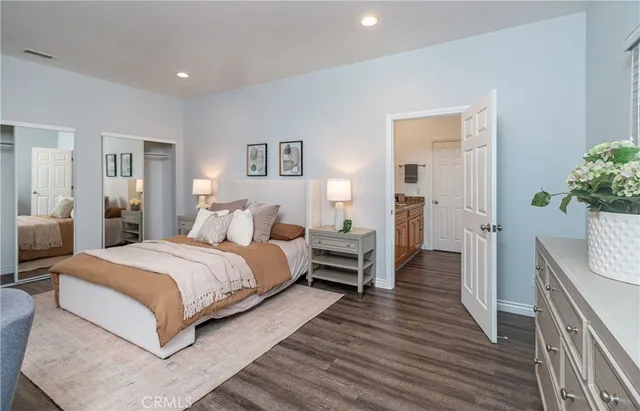 a spacious bedroom with a bed and a chandelier