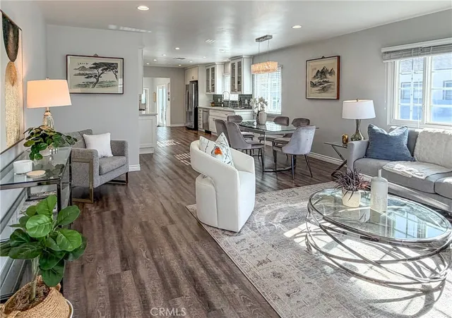a living room with fireplace furniture and a wooden floor