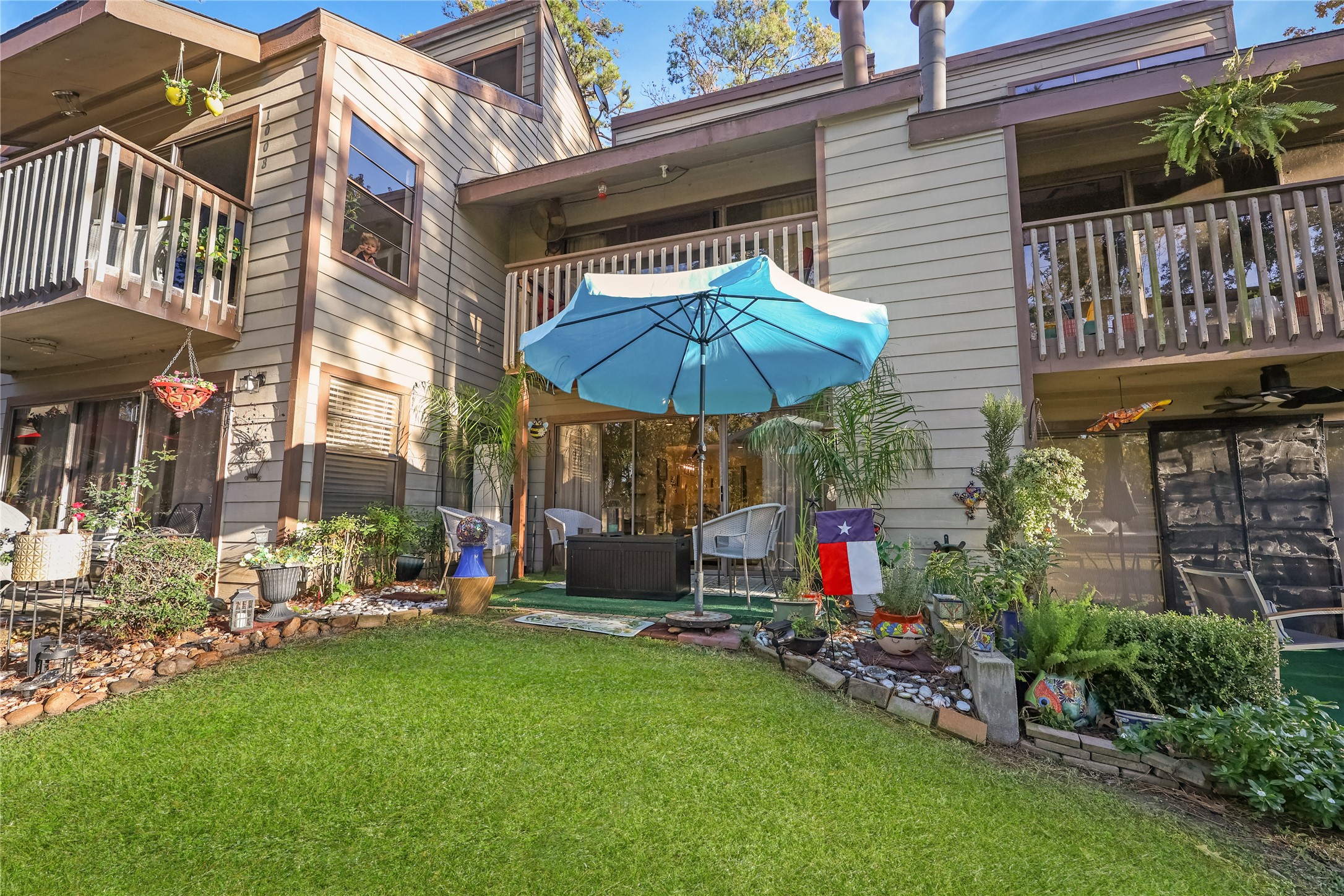 a view of a chair and table under an umbrella