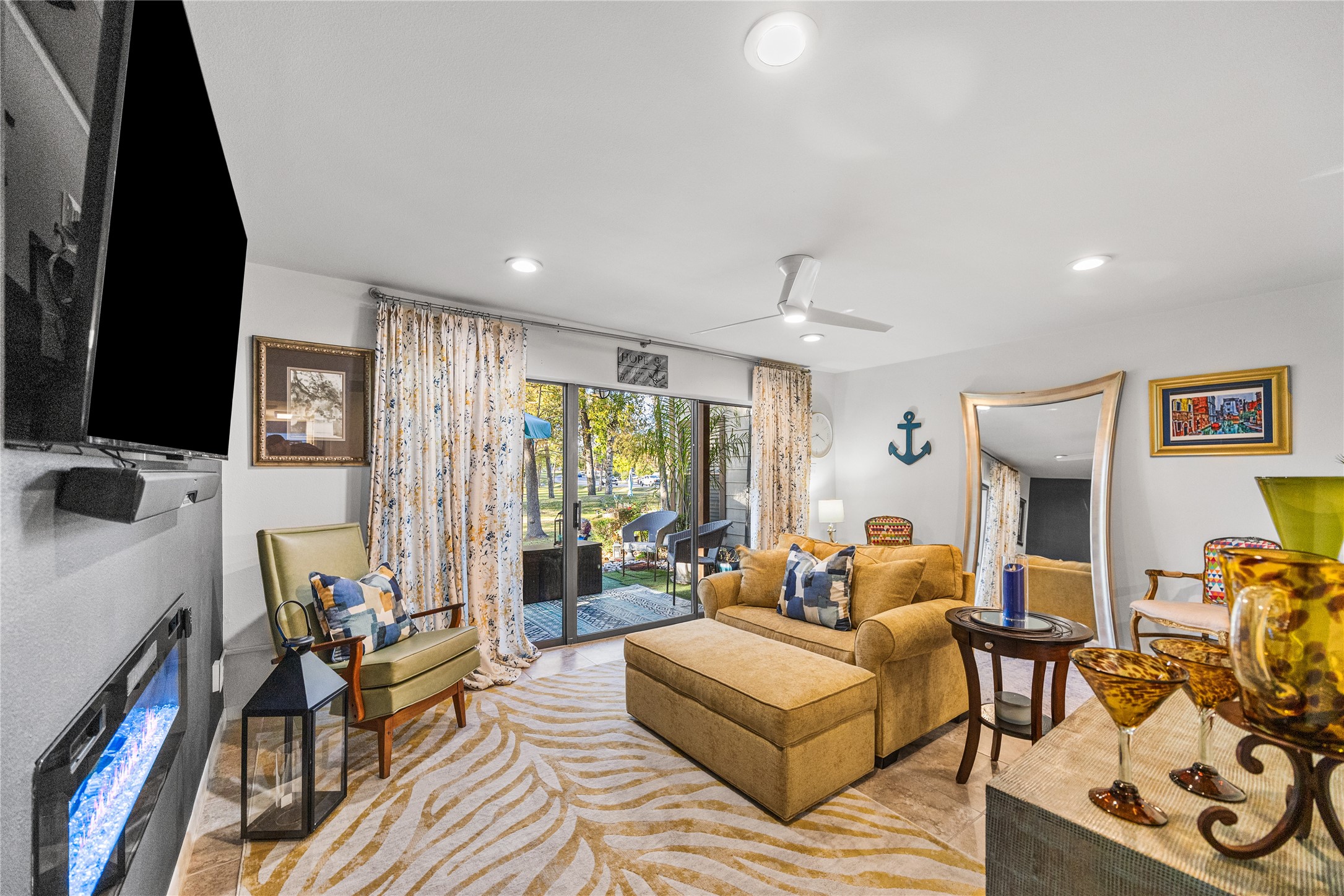 12900 Walden Road, Unit 1009J Montgomery, TX 77356 - Photo 13 of 24 a living room with fireplace furniture and a flat screen tv