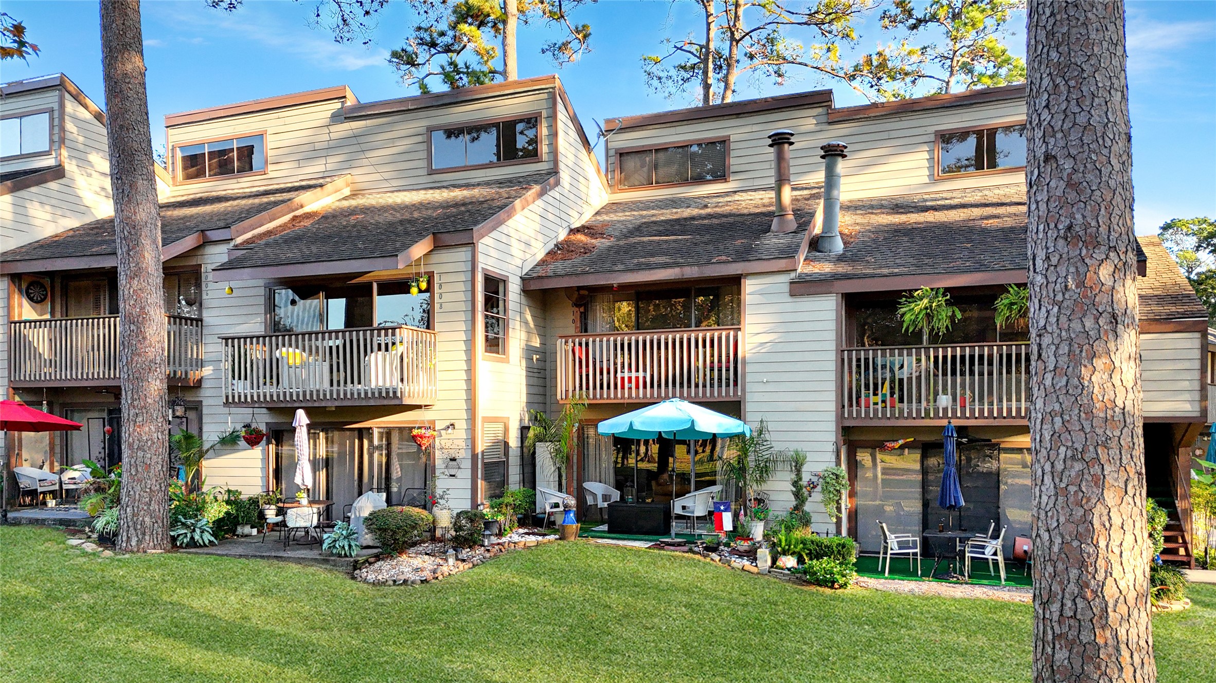 12900 Walden Road, Unit 1009J Montgomery, TX 77356 - Photo 20 of 24 a view of a building with a yard and sitting area
