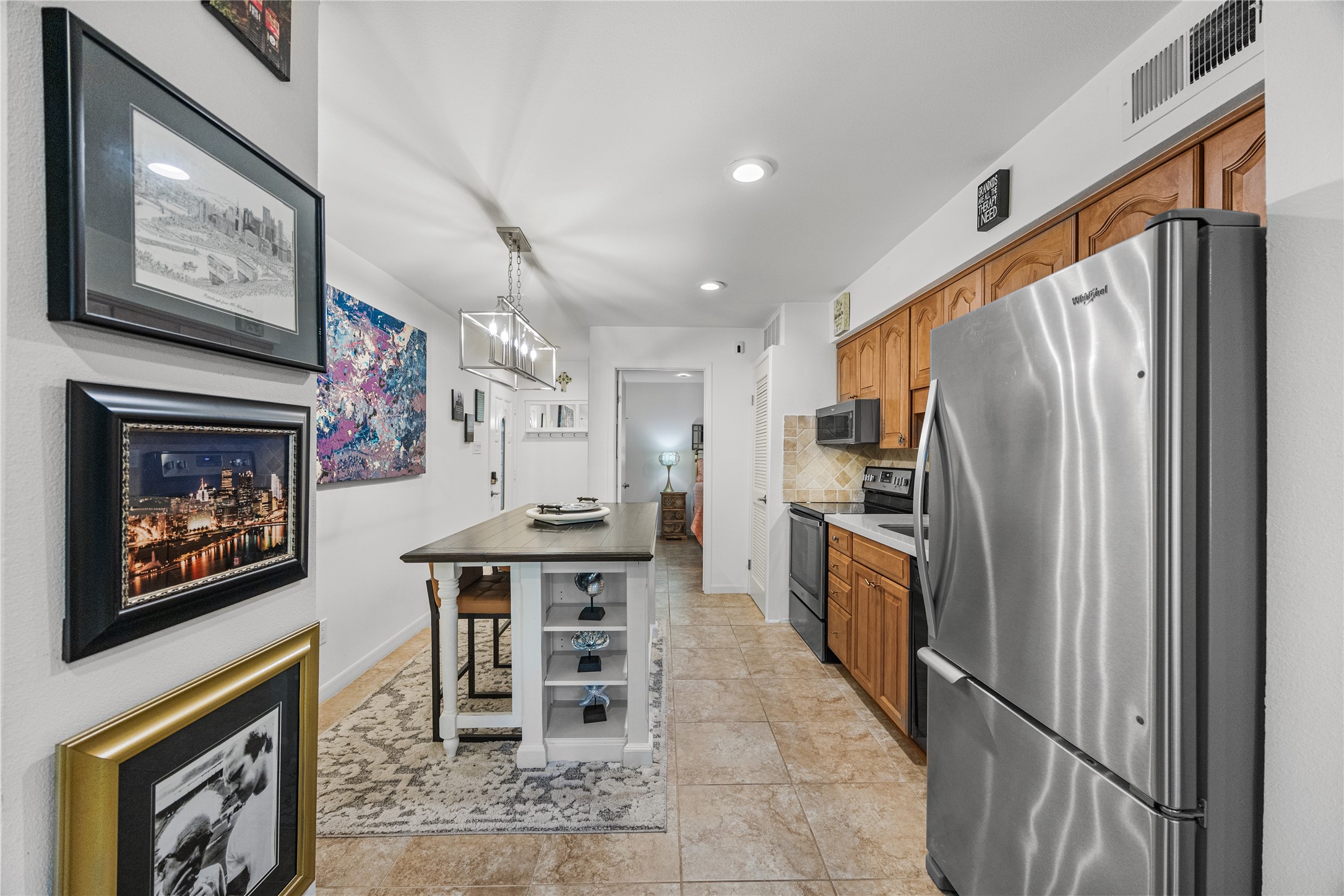 12900 Walden Road, Unit 1009J Montgomery, TX 77356 - Photo 8 of 24 a kitchen with stainless steel appliances granite countertop a refrigerator and a stove top oven