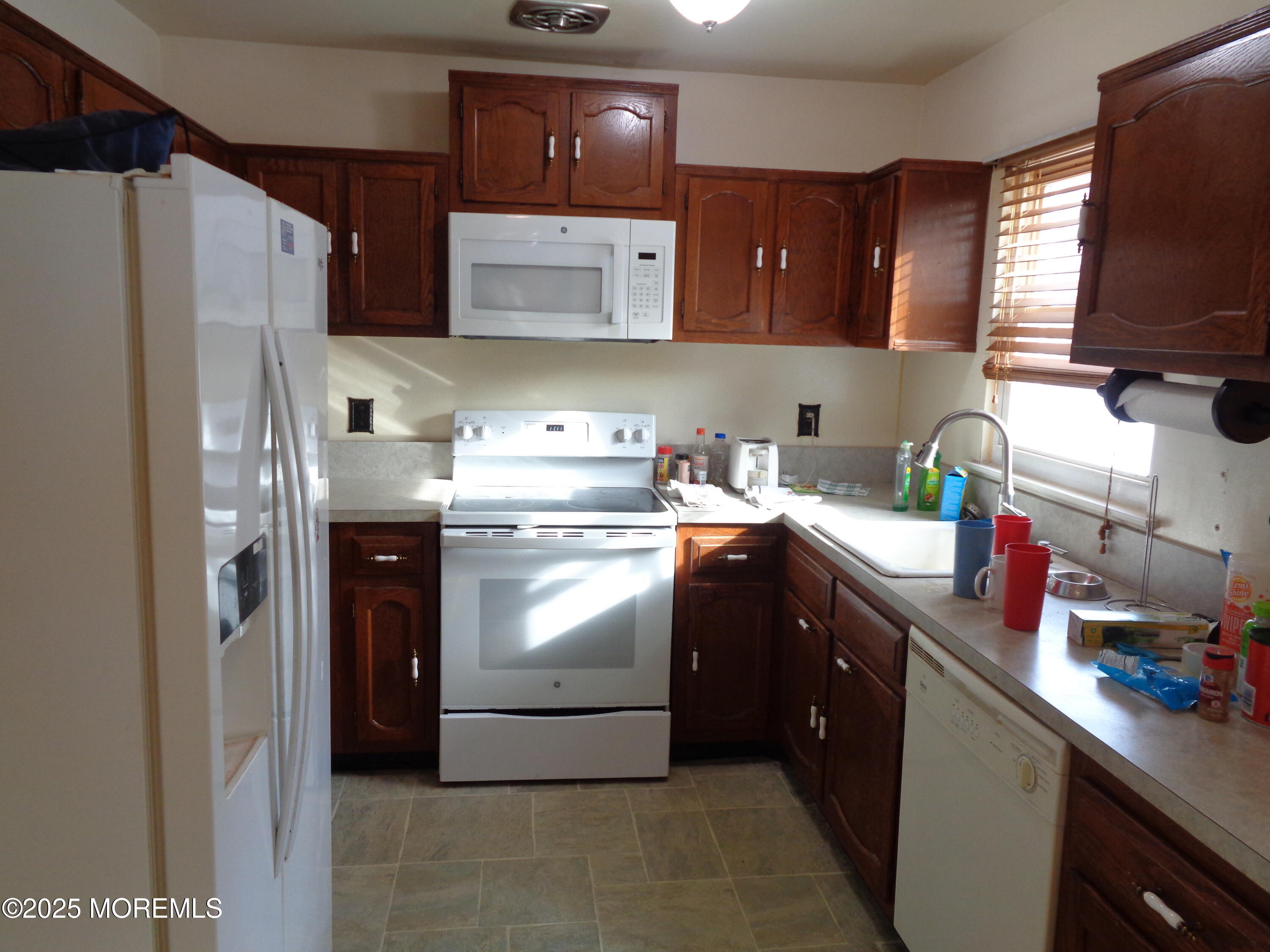 22 A Homestead Drive Whiting, NJ 08759 - Photo 4 of 15 a kitchen with stainless steel appliances granite countertop a refrigerator a sink a stove and wooden cabinets