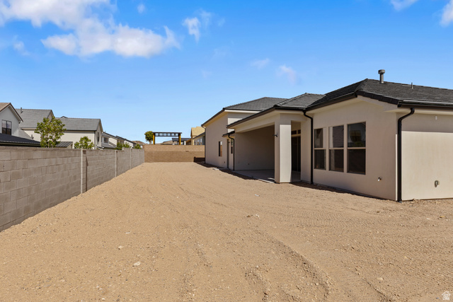 2955 East Rimrunner Drive St. George, UT 84790 - Photo 31 of 35 Spacious rear yard with a concrete block privacy wall and a covered patio area