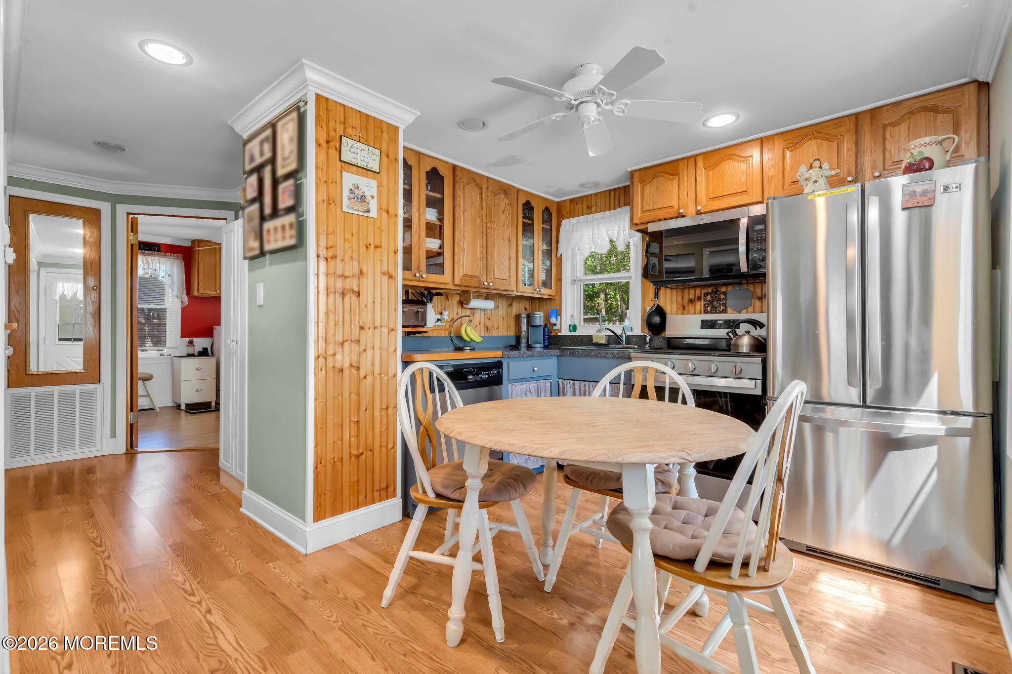 437 Shady Lane Howell, NJ 07731 - Photo 7 of 21 a kitchen with stainless steel appliances granite countertop a refrigerator a stove top oven a sink dishwasher and white cabinets with wooden floor