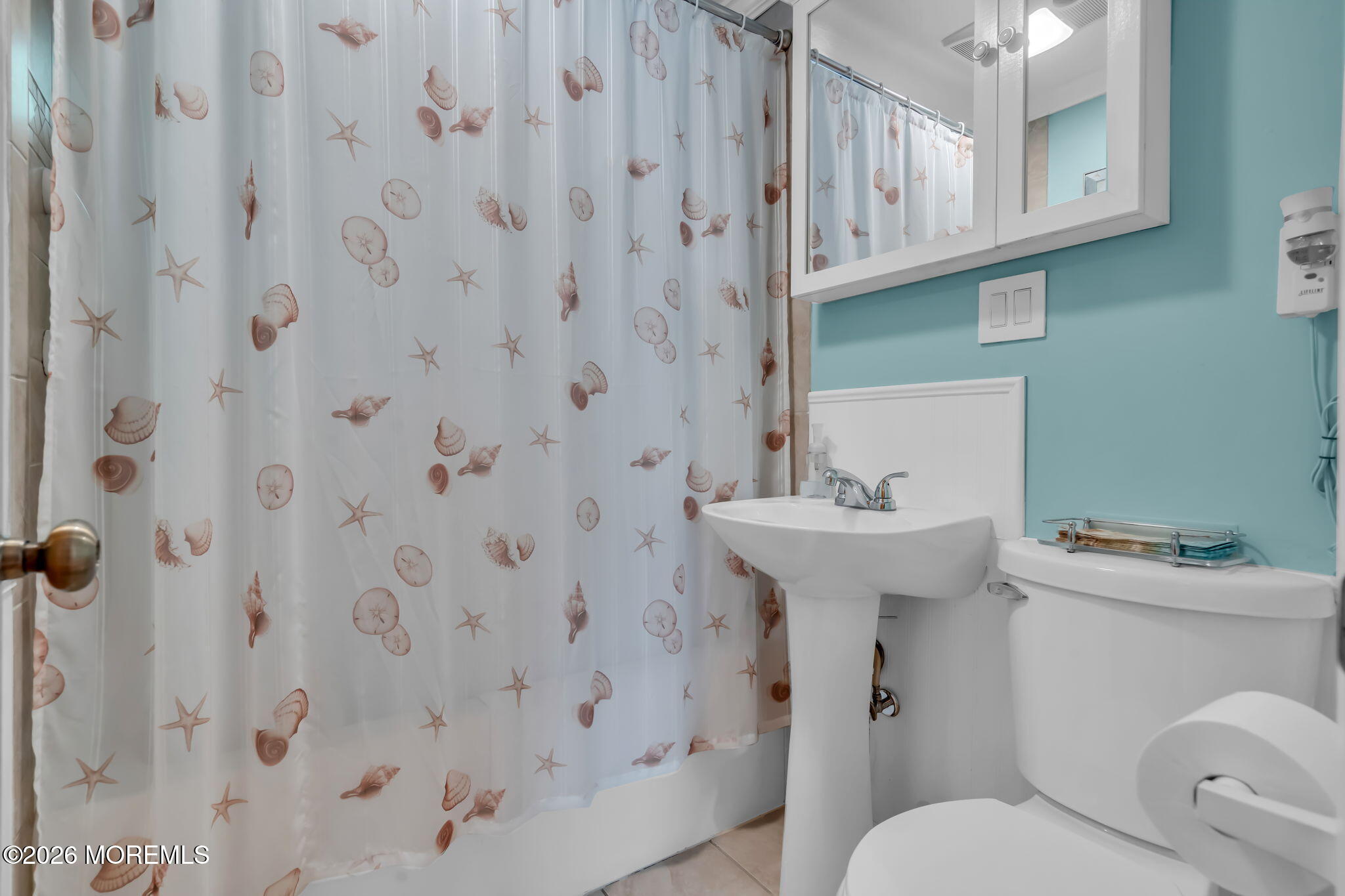 437 Shady Lane Howell, NJ 07731 - Photo 9 of 21 a bathroom with a sink a toilet and shower curtain
