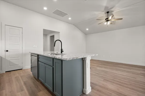 a kitchen with sink and cabinets