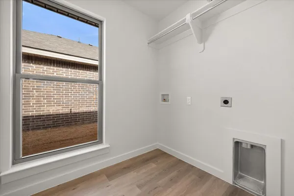 a view of a small space with wooden floor and a window