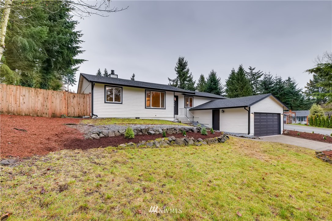 31404 3rd Place South Federal Way, WA 98003 - Photo 2 of 24 a view of house with yard and trees in the background