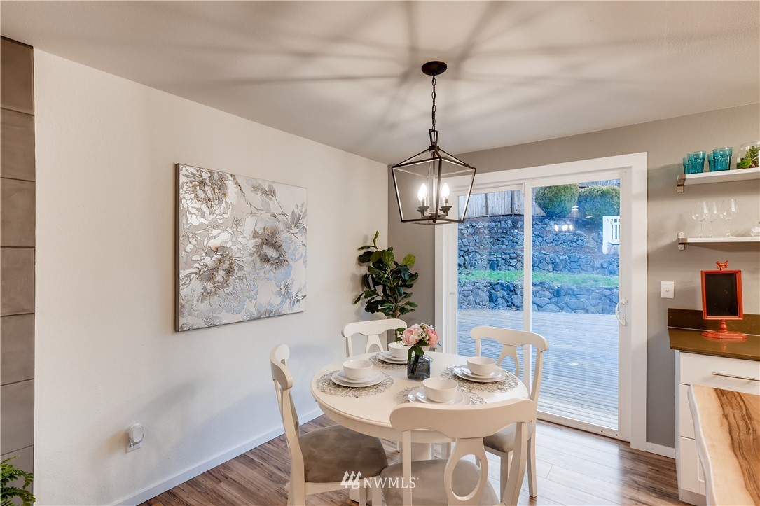 31404 3rd Place South Federal Way, WA 98003 - Photo 11 of 24 a view of a dining room with furniture wooden floor and chandelier