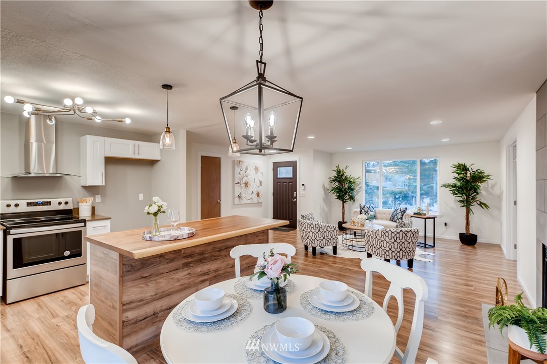 31404 3rd Place South Federal Way, WA 98003 - Photo 12 of 24 a kitchen with stainless steel appliances kitchen island granite countertop a table and chairs in it