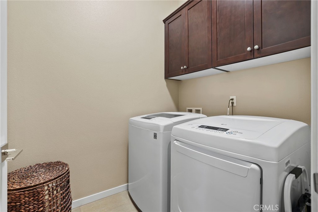 65 Listo Street Rancho Mission Viejo, CA 92694 - Photo 30 of 67 Well-designed laundry area featuring cabinetry, counter space, and modern functionality.