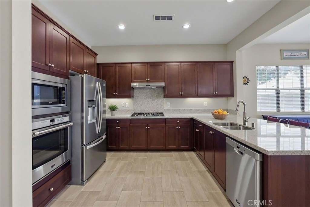 65 Listo Street Rancho Mission Viejo, CA 92694 - Photo 4 of 67 Beautiful spacious kitchen with warm tone cabinetry