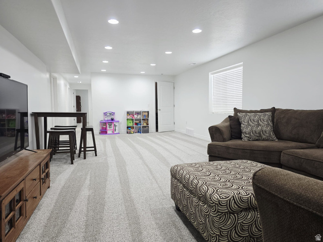 1437 925 South Vernal, UT 84078 - Photo 20 of 47 Spacious finished lower level featuring recessed lighting, a window with blinds, and light-toned patterned carpeting