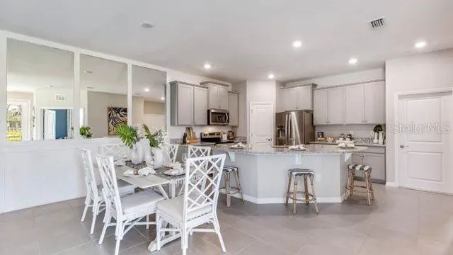 a kitchen with a table and chairs in it