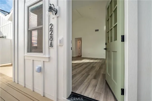 a view of a hallway with wooden floor and entryway