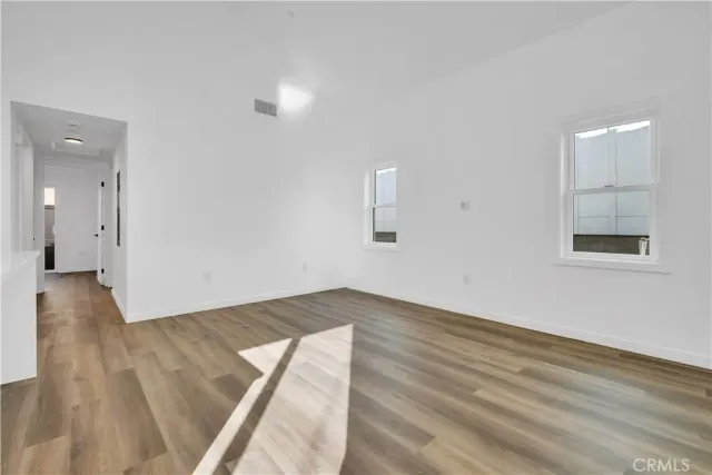 a view of an empty room and wooden floor