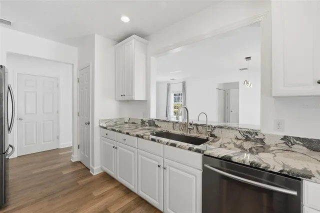 a view of a kitchen with a sink and cabinets